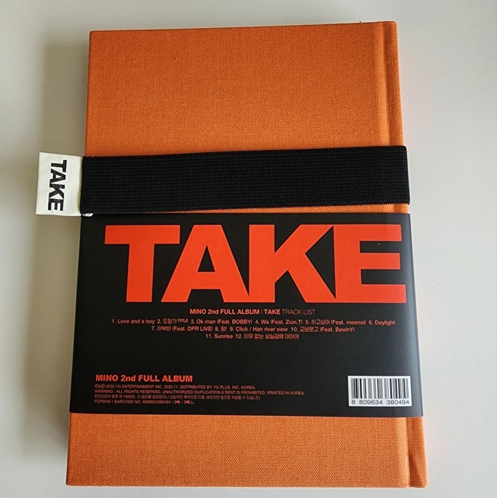 Mino TAKE Album with Black Band and Red Text